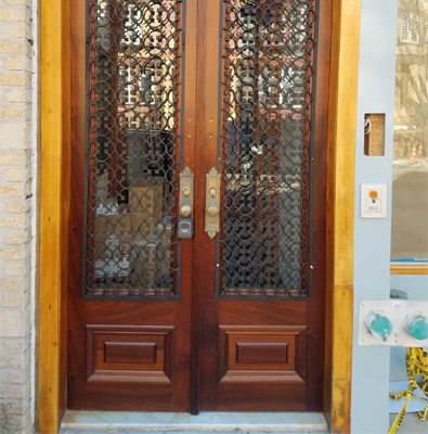 Wooden Door With an Intricate Metal Grill